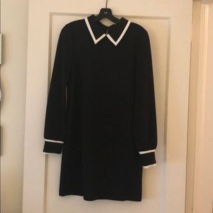Black dress with collar. white piping details